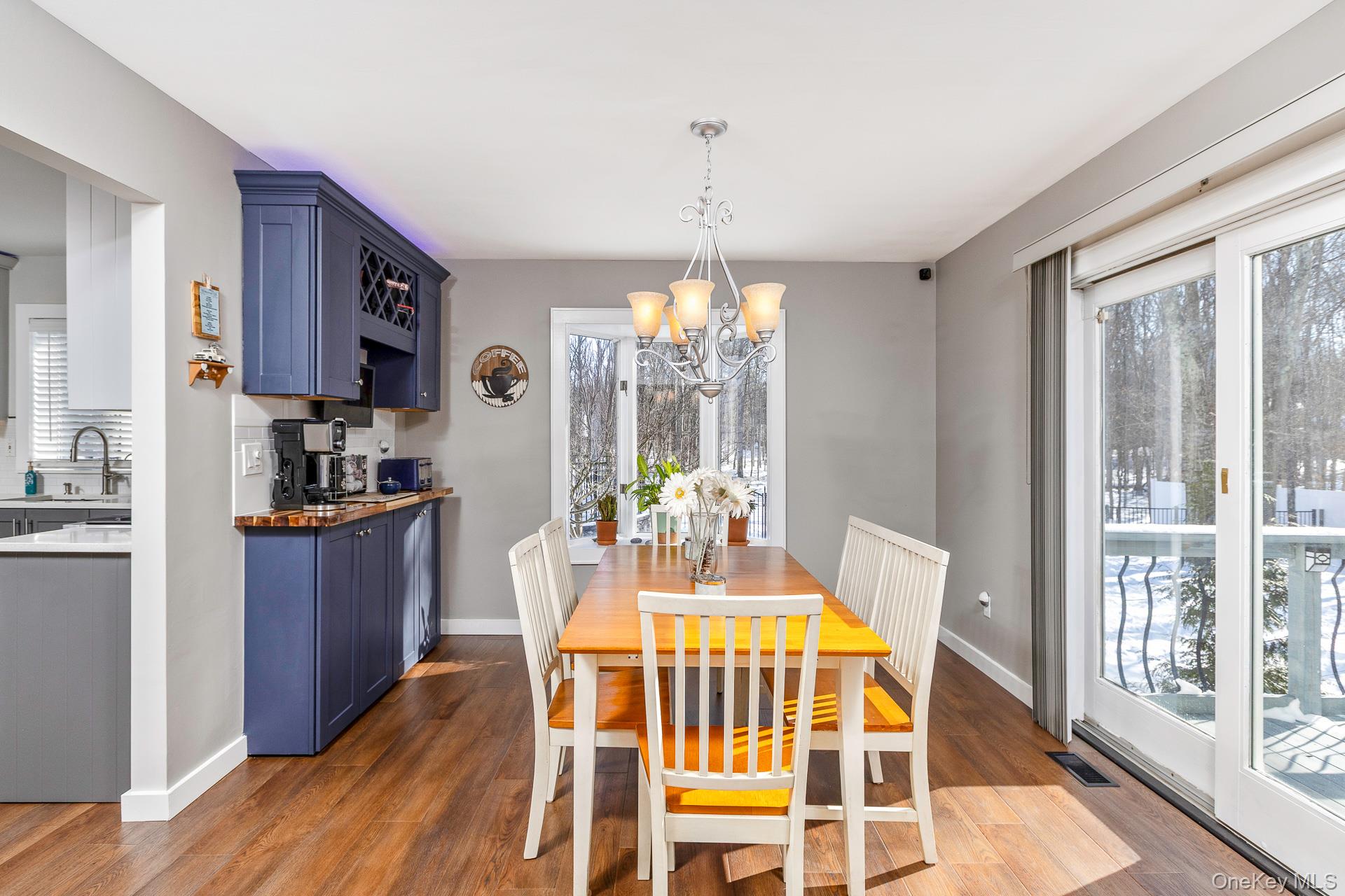 503 Wading River Road Manorville, NY 11949 - Photo 10 of 45 Dining space with dark wood-style floors and a chandelier