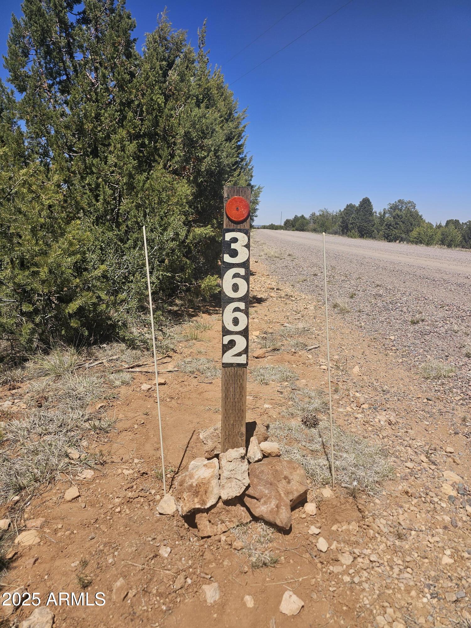 3662 Sunset Ridge Loop, Unit 143 Happy Jack, AZ 86024 - Photo 4 of 8 a street sign is next to a road