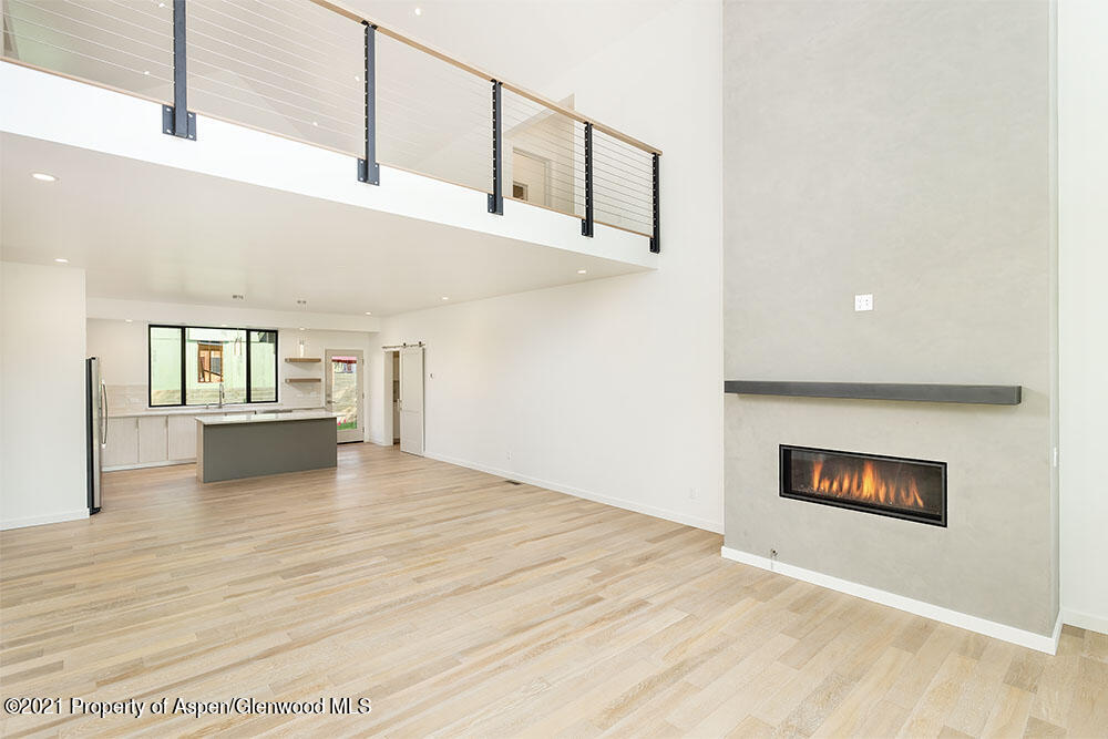 132 Valley Court Basalt, CO 81621 - Photo 11 of 38 a view of a livingroom with wooden floor and kitchen