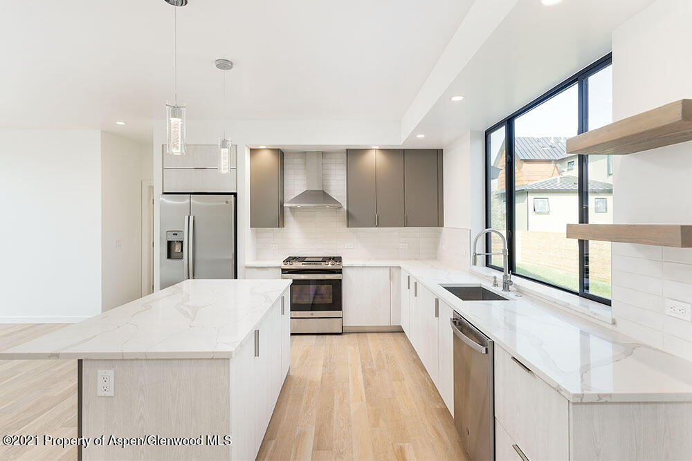 132 Valley Court Basalt, CO 81621 - Photo 13 of 38 a kitchen with stainless steel appliances a sink stove and refrigerator