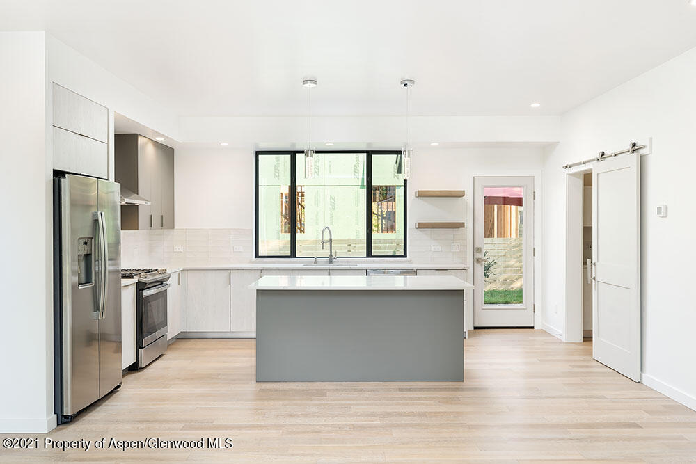 132 Valley Court Basalt, CO 81621 - Photo 14 of 38 a kitchen with stainless steel appliances granite countertop a stove a refrigerator and a sink