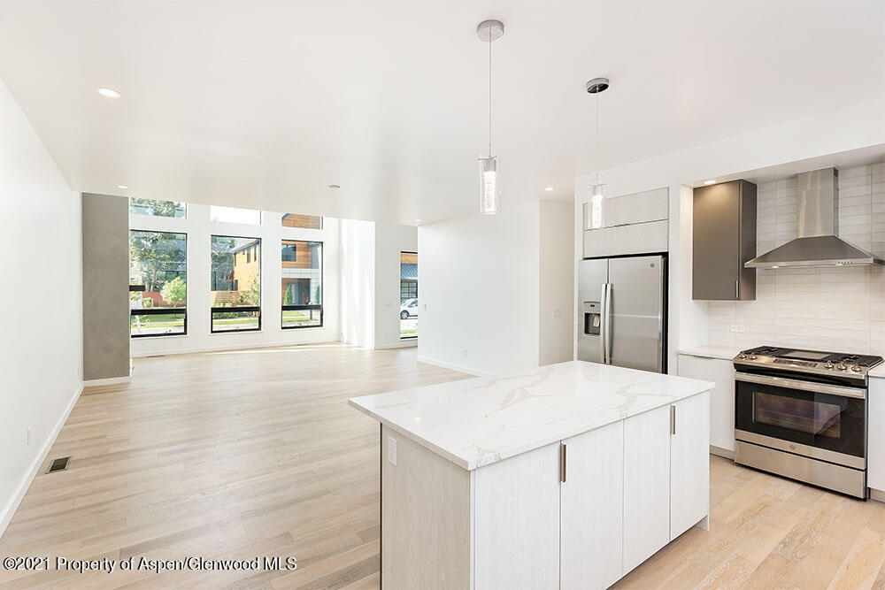 132 Valley Court Basalt, CO 81621 - Photo 15 of 38 a kitchen with granite countertop a stove a sink and a refrigerator