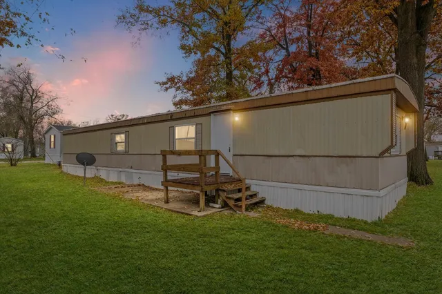 a view of backyard with a garden and deck
