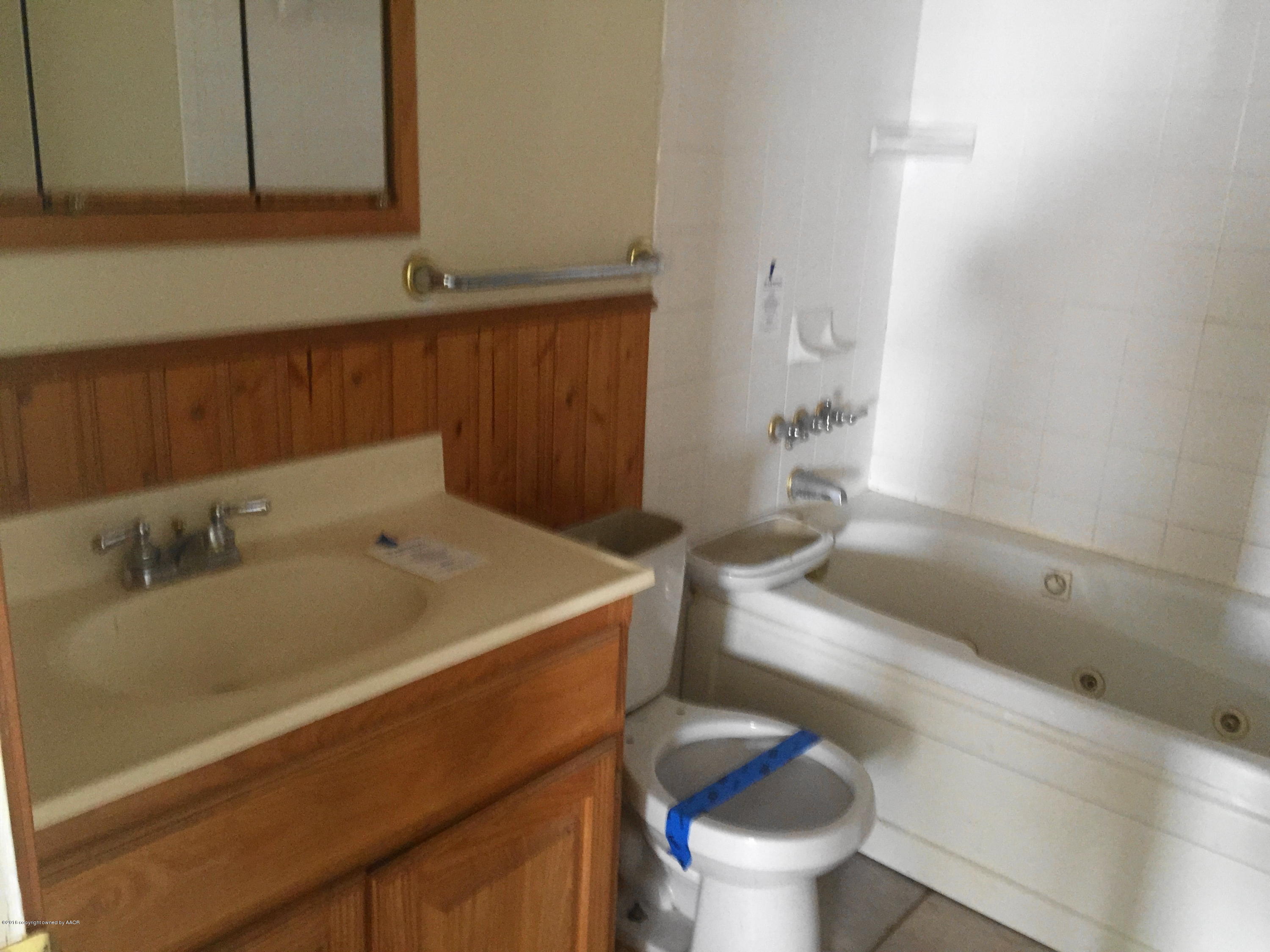 906 South Austin Street Amarillo, TX 79102 - Photo 6 of 10 a bathroom with a sink and a toilet