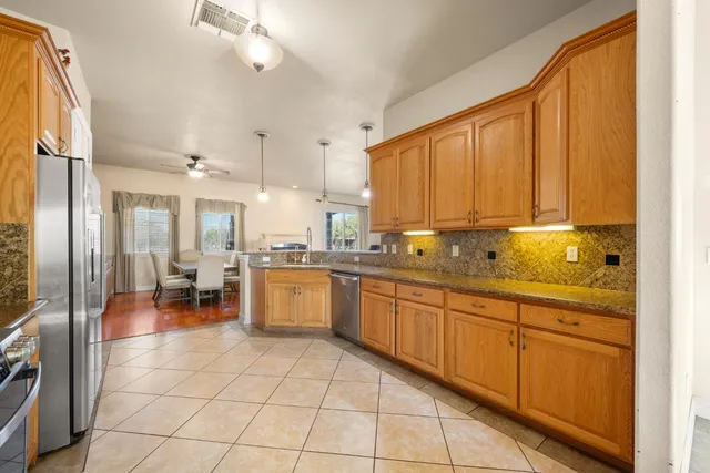 a large kitchen with a large window and stainless steel appliances
