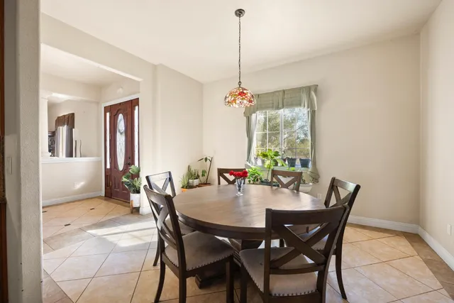 a view of a dining room with furniture window and outside view