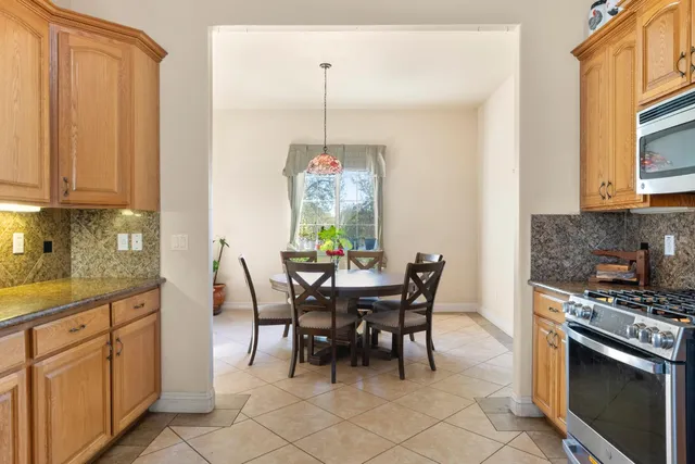 a view of a dining room with furniture and chandelier