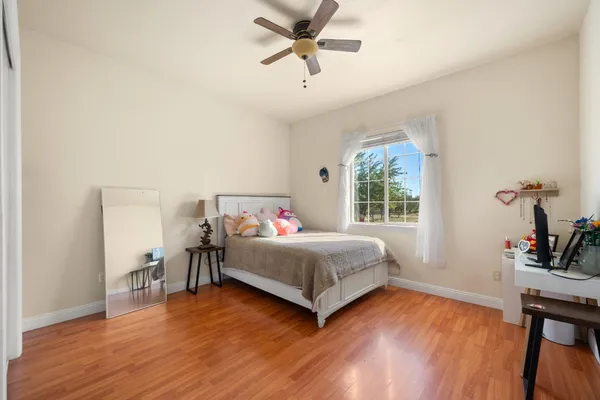 a bedroom with a bed and a chair
