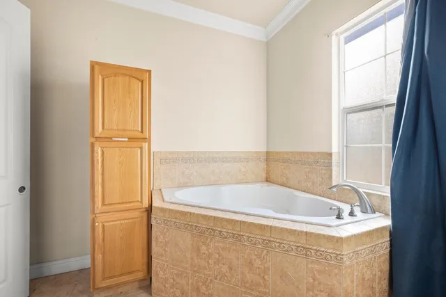 a bath tub sitting next to a window