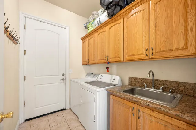 a view of a sink and dishwasher with cabinets