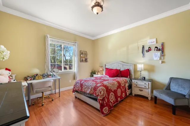 a bedroom with a bed and a chair