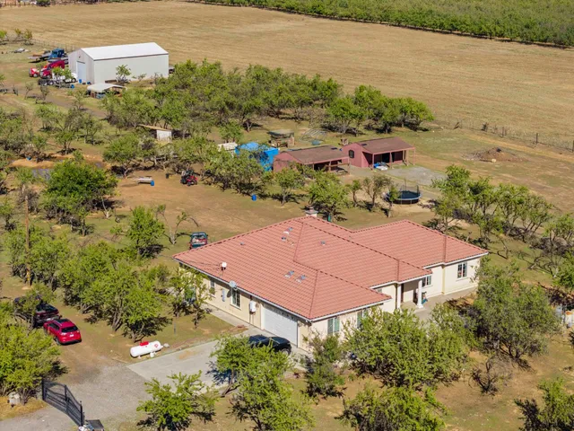 an aerial view of house with yard