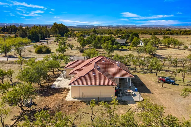 a view of a house with pool and sitting area