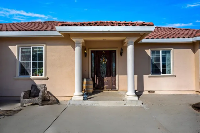a view of a house with potted plants