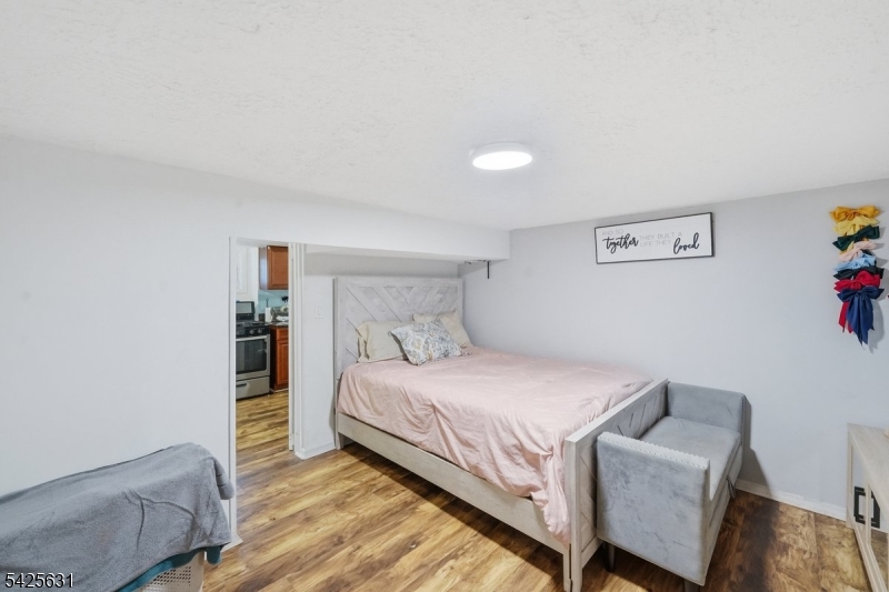 60 Westervelt Place Lodi, NJ 07644 - Photo 36 of 48 a bedroom with a bed and a chair