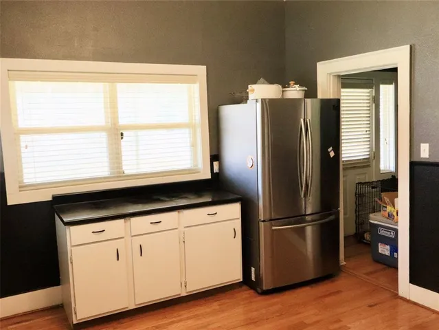 a kitchen with granite countertop stainless steel appliances a refrigerator sink and cabinets