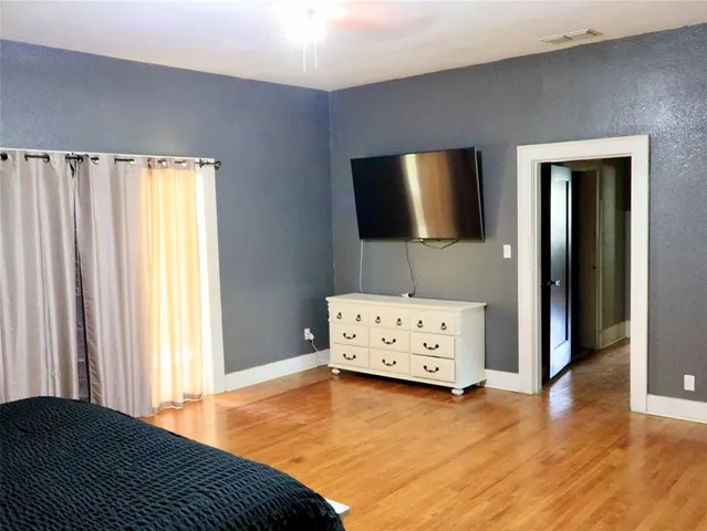 a bedroom with a bed and flat screen tv