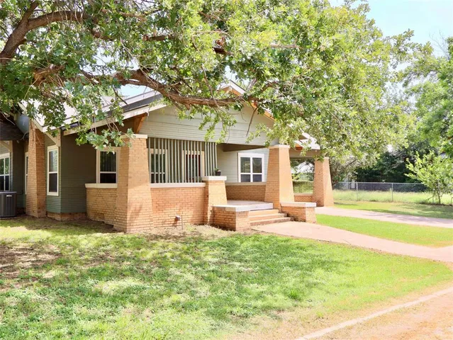 a view of a house with pool and a yard