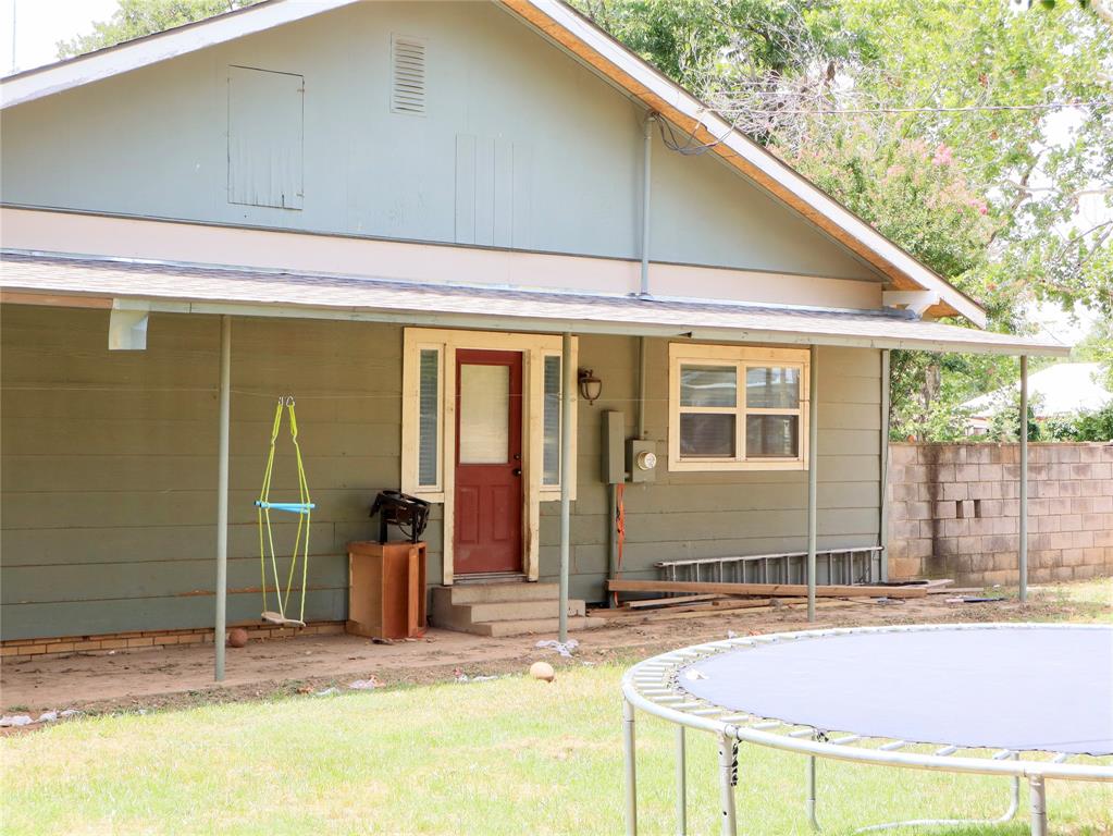 203 Bennett Street Strawn, TX 76475 - Photo 21 of 28 a front view of a house with basket ball court and glass door