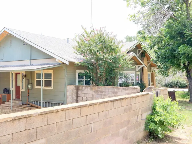 a view of house with a yard and sitting area