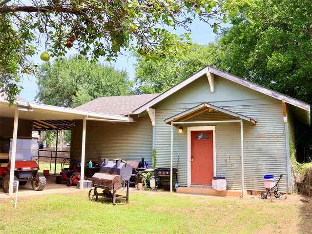 a front view of a house with a yard outdoor seating and garage