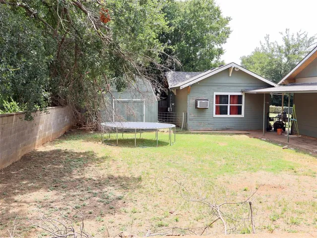 a view of a house with pool and chairs