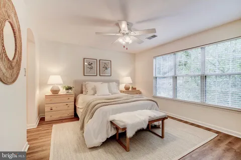a spacious bedroom with a bed and a large window