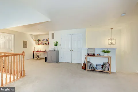 a view of a livingroom with a baby crib and a couch