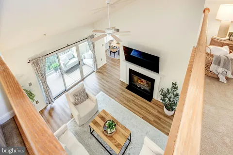a living room with furniture wooden floor and a flat screen tv