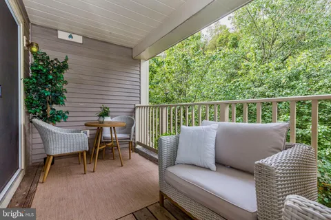 a balcony with furniture and garden view