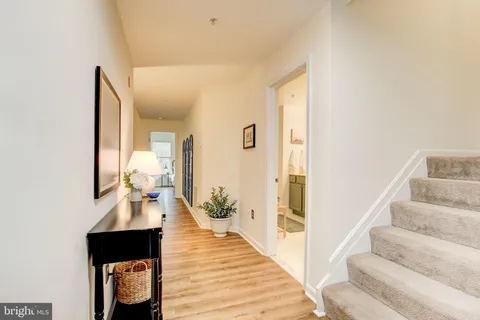 a view of entryway and hall with wooden floor
