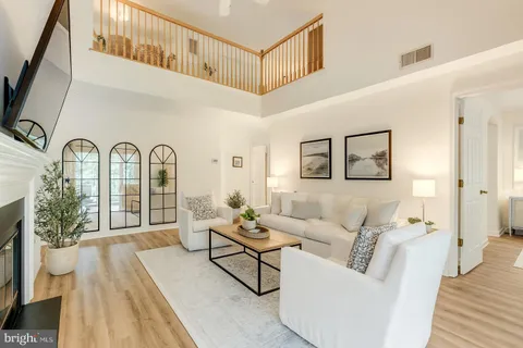 a living room with patio furniture and a fireplace