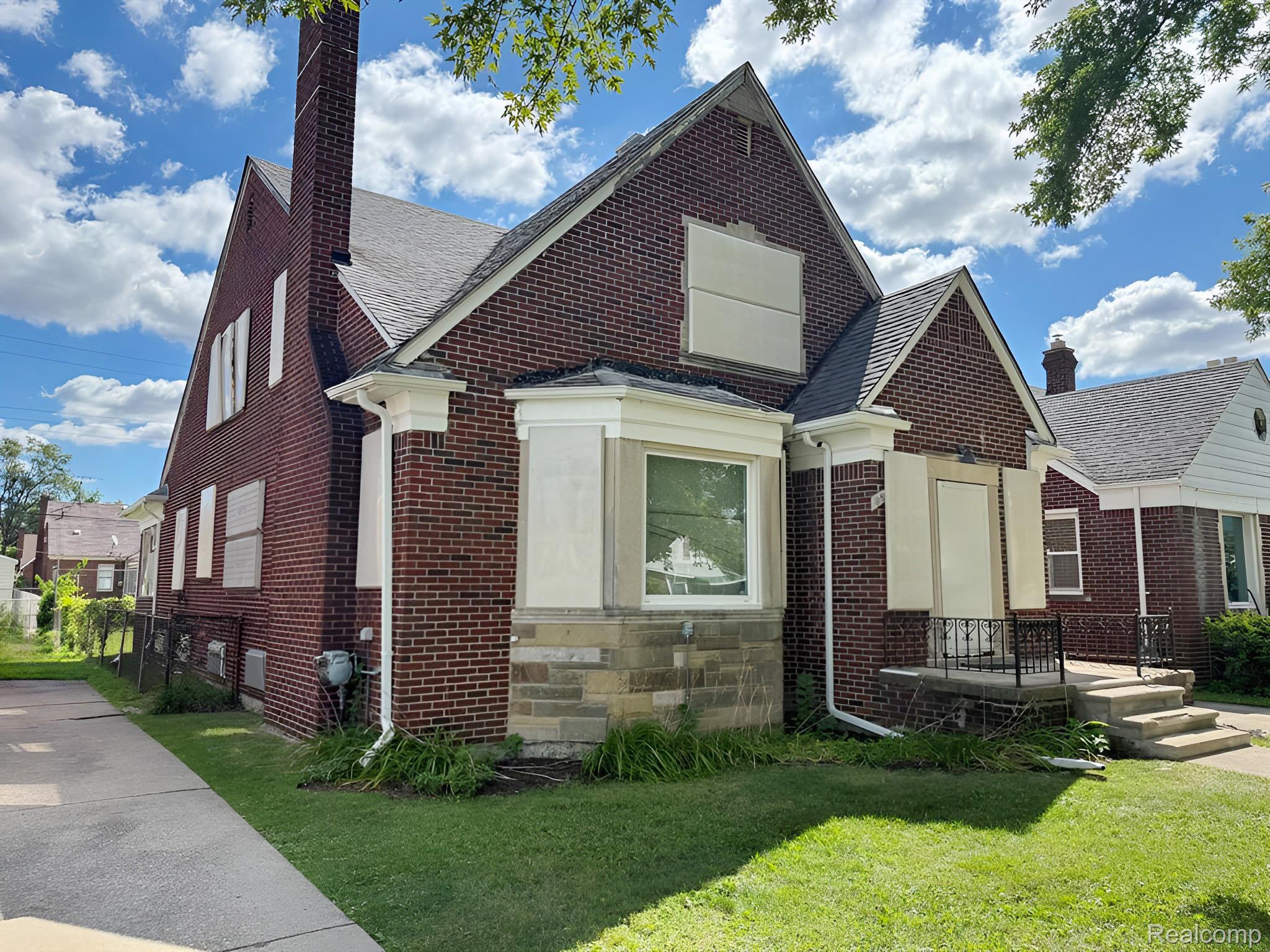 18700 Whitcomb Detroit, MI 48235 - Photo 2 of 12 Brick exterior residence featuring a gabled roofline and a prominent chimney