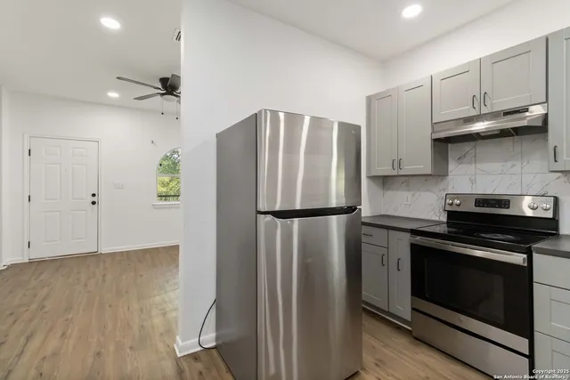 a kitchen with stainless steel appliances a refrigerator stove and microwave