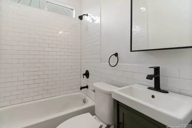 a bathroom with a sink a toilet and bathtub