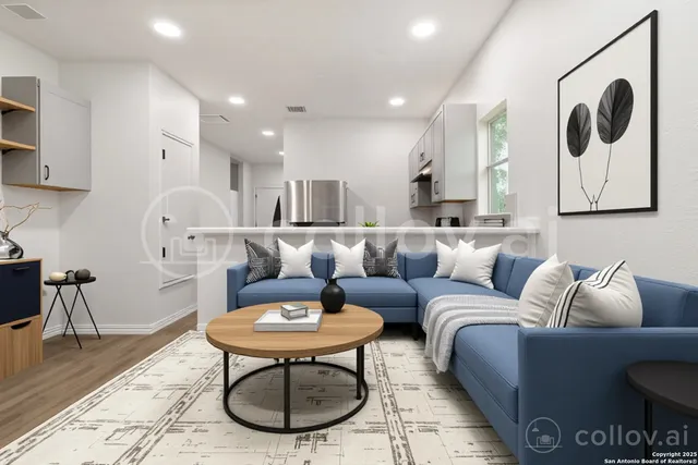 a living room with furniture kitchen and a table