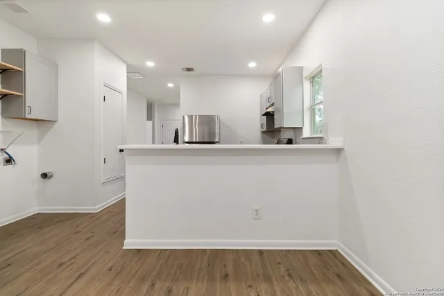 a view of a kitchen with wooden floor