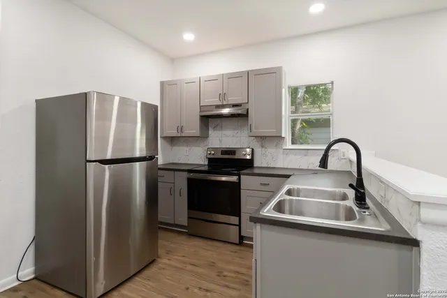 a kitchen with a refrigerator and a sink