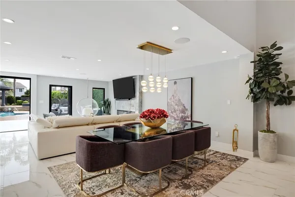 a kitchen with stainless steel appliances kitchen island granite countertop a sink a stove and a refrigerator
