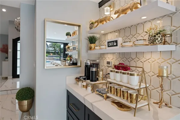 a view of swimming pool with lawn chairs under an umbrella
