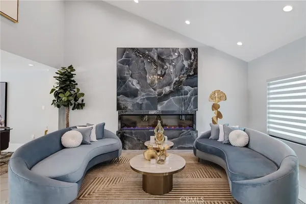 a living room with furniture and a chandelier