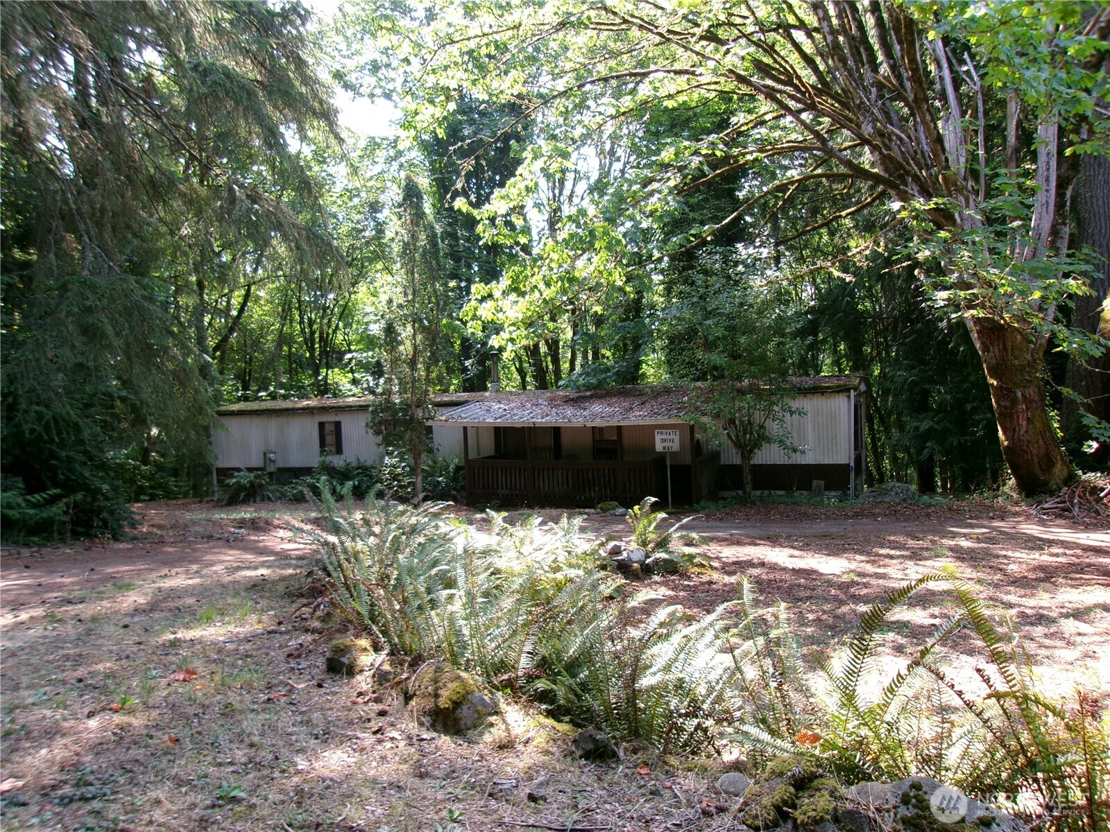 6724 Southeast Sedgwick Road Port Orchard, WA 98366 - Photo 1 of 14 a backyard of a house with lots of green space