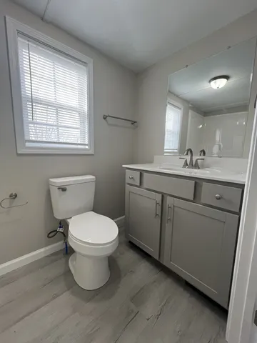a bathroom with a toilet sink and mirror