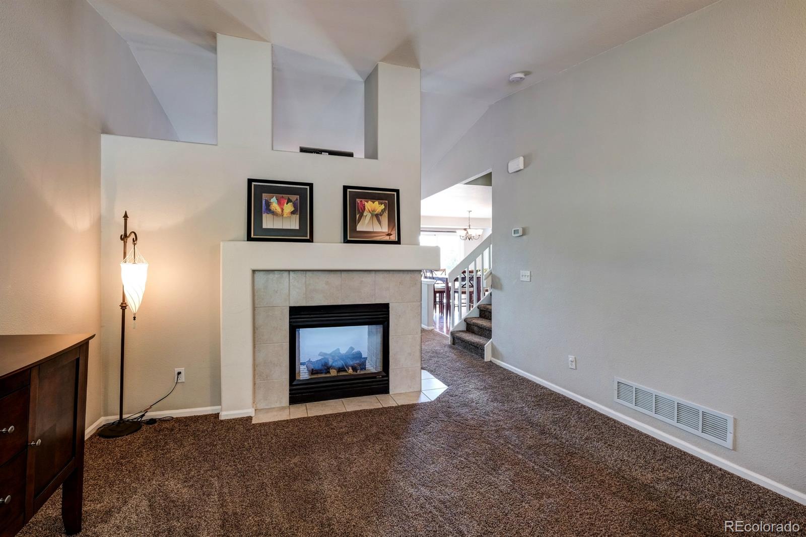 1045 Riddlewood Lane Highlands Ranch, CO 80129 - Photo 14 of 26 a living room with furniture and a fireplace
