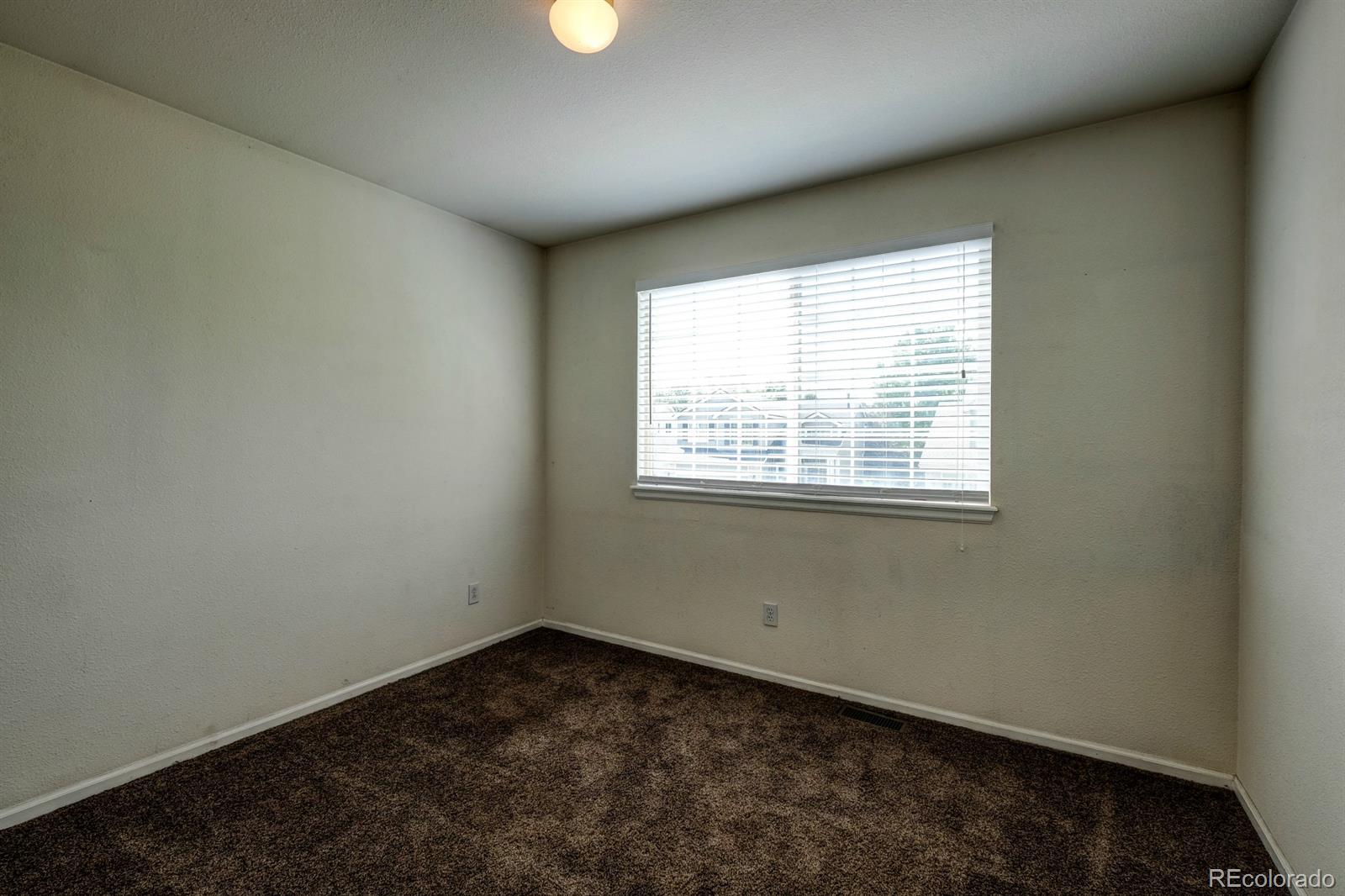 1045 Riddlewood Lane Highlands Ranch, CO 80129 - Photo 18 of 26 an empty room with a window