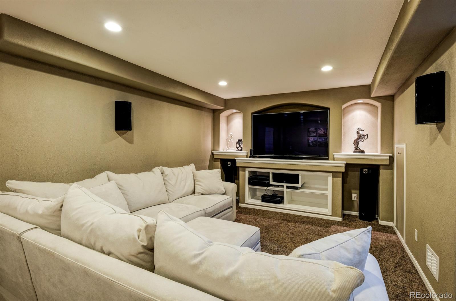 1045 Riddlewood Lane Highlands Ranch, CO 80129 - Photo 19 of 26 a living room with furniture and a flat screen tv