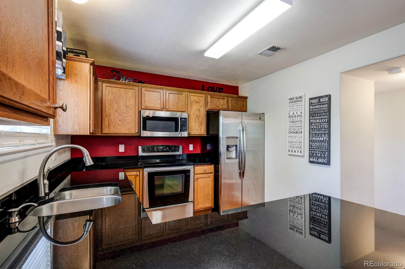 1045 Riddlewood Lane Highlands Ranch, CO 80129 - Photo 5 of 26 a utility room with dryer and washer