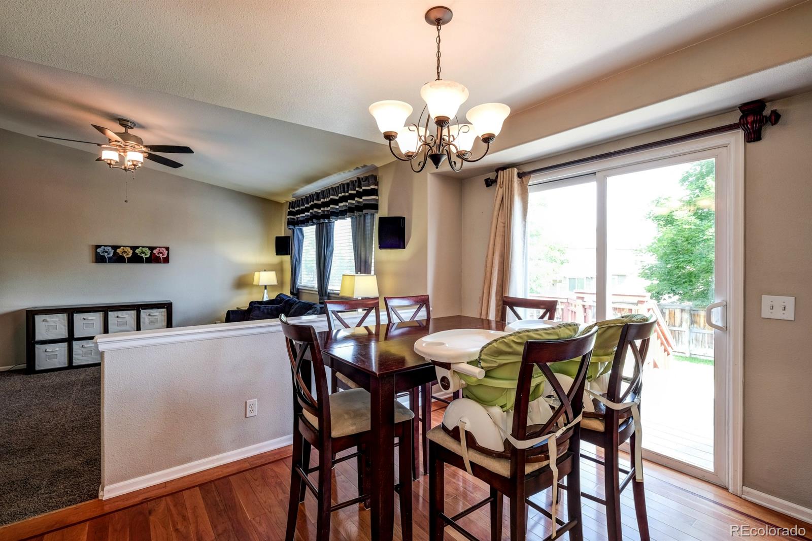 1045 Riddlewood Lane Highlands Ranch, CO 80129 - Photo 6 of 26 a view of a dining room with furniture window and wooden floor