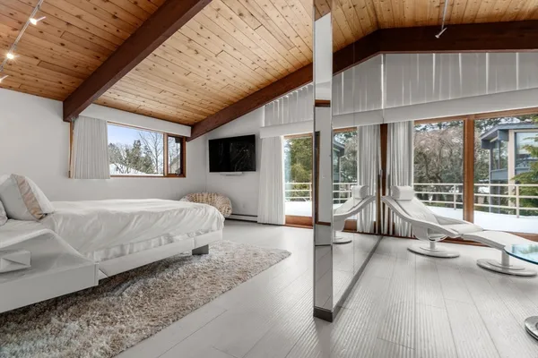 a spacious bedroom with a large bed and a large window