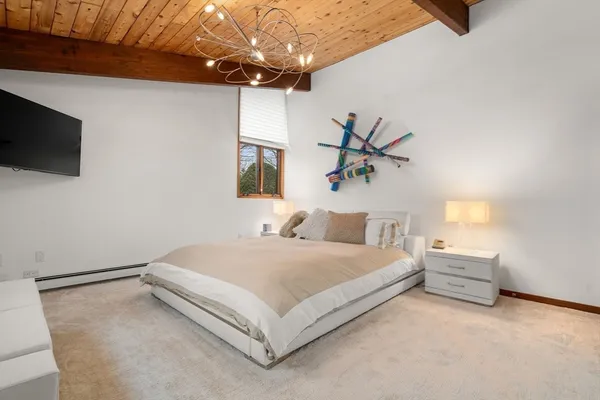 a bedroom with a bed and a chandelier